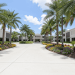 Commercial HOA landscaping Palm Beach office park entrance with tropical plants and palm trees